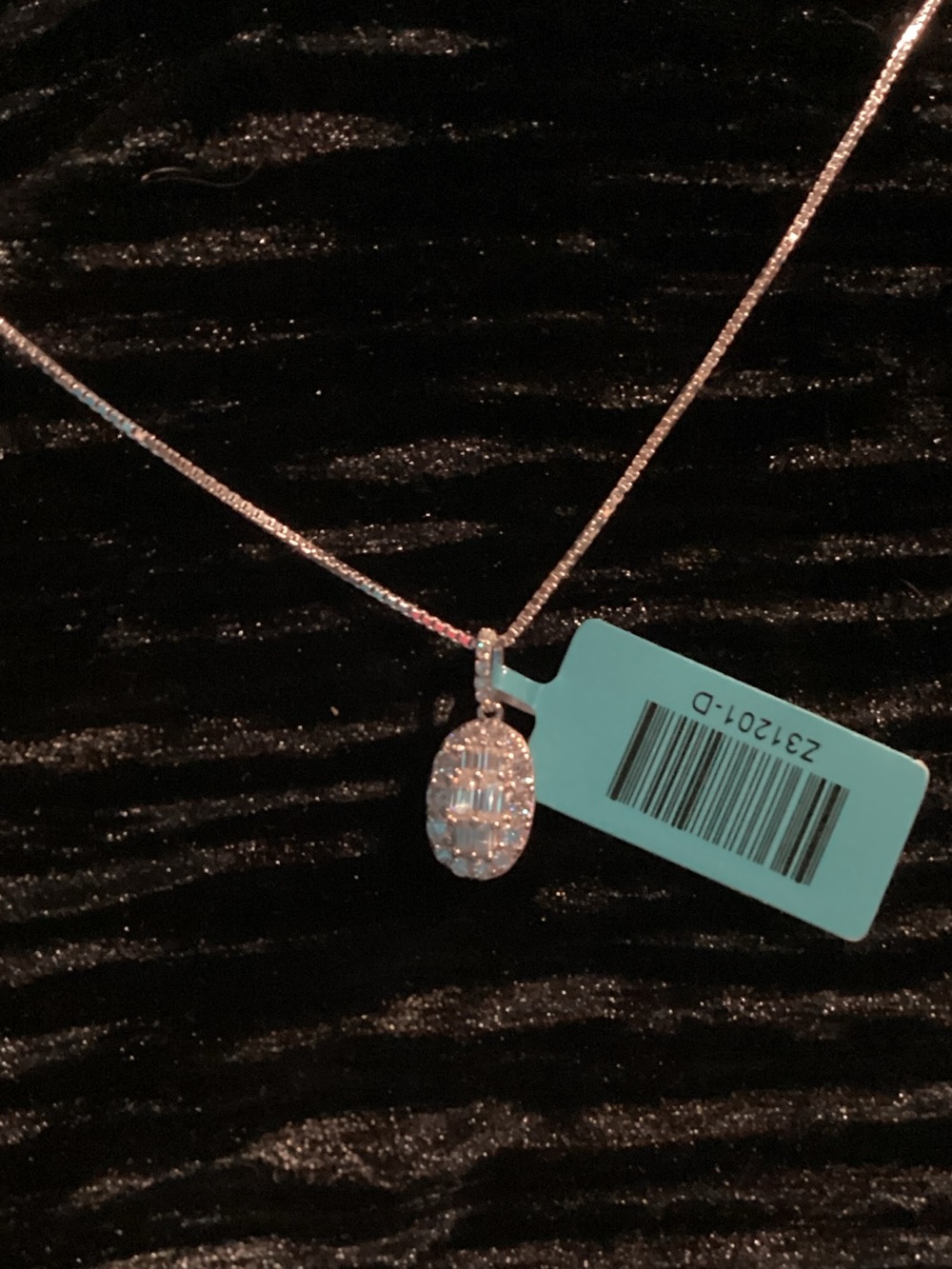 0.90 TCW Oval Pavé Moissanite Pendant paired with an 18 in. silver box chain